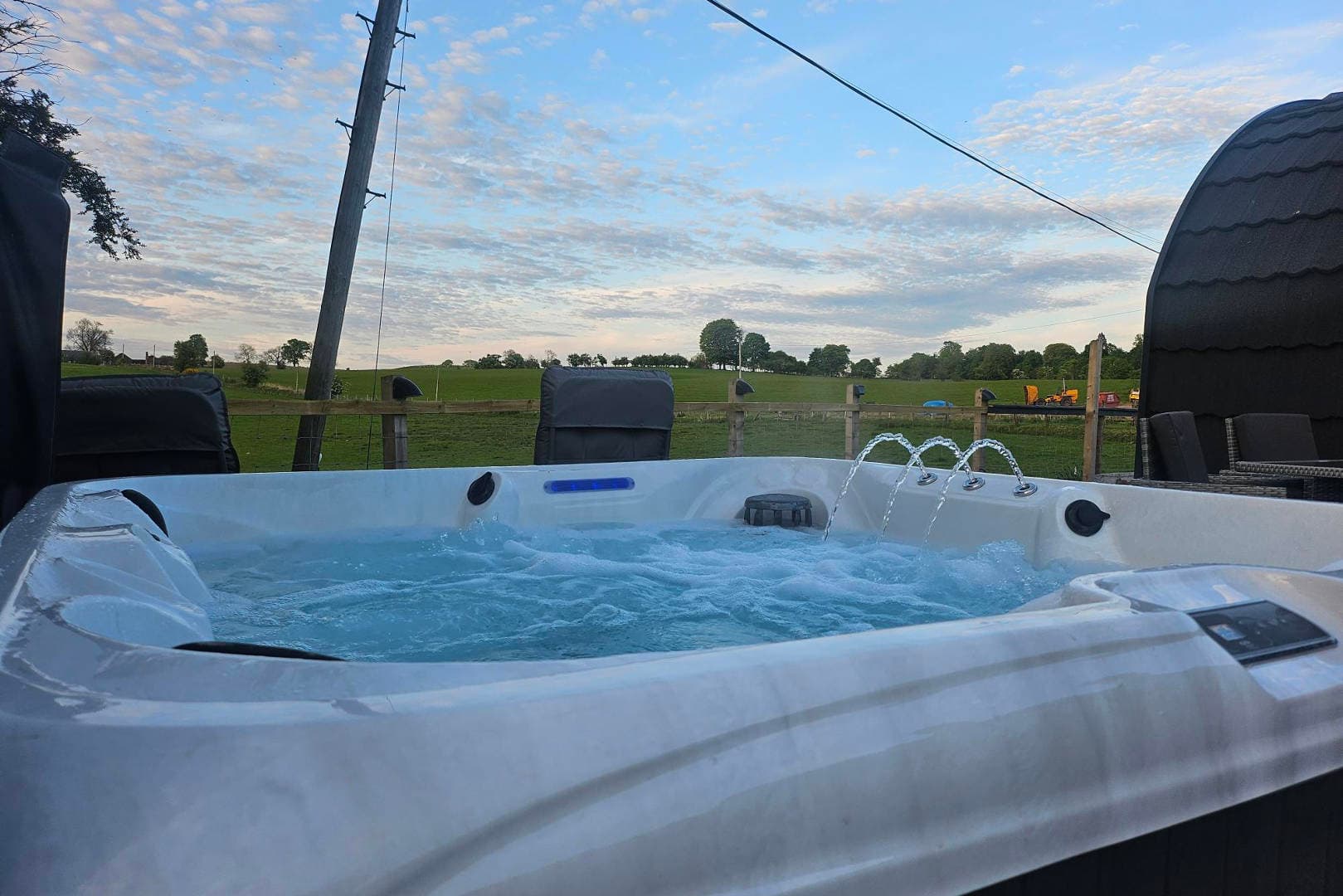 The Thistle Pod's hot tub, bubbling under its covered gazebo