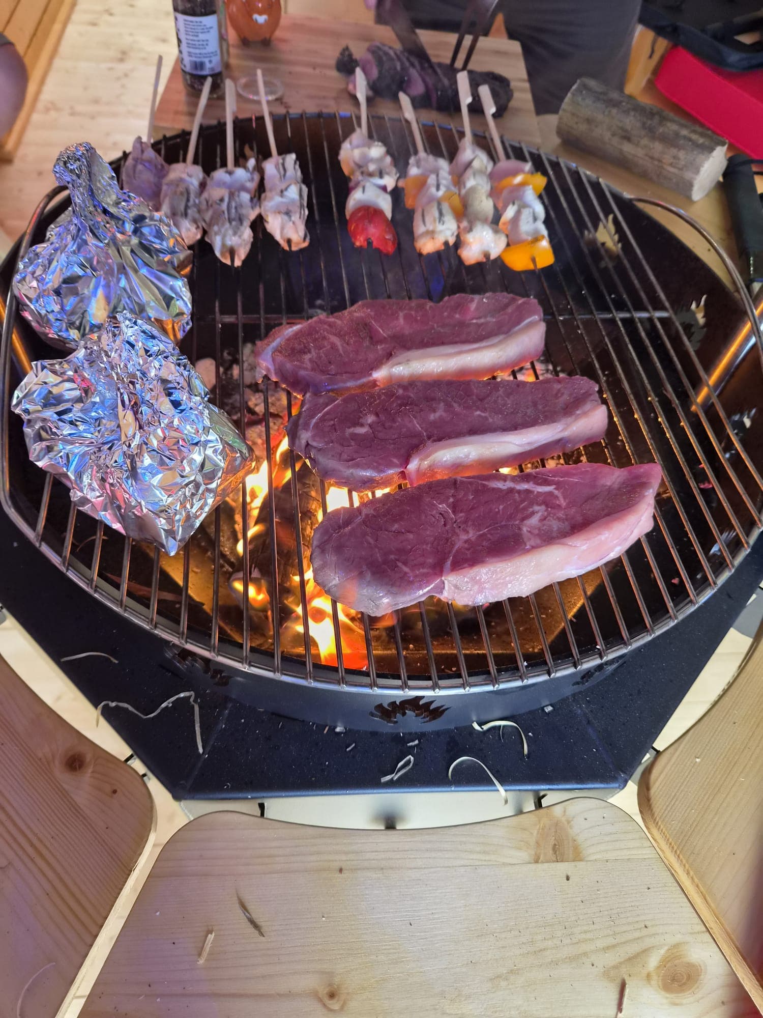 Steaks and skewers grilling in the BBQ hut