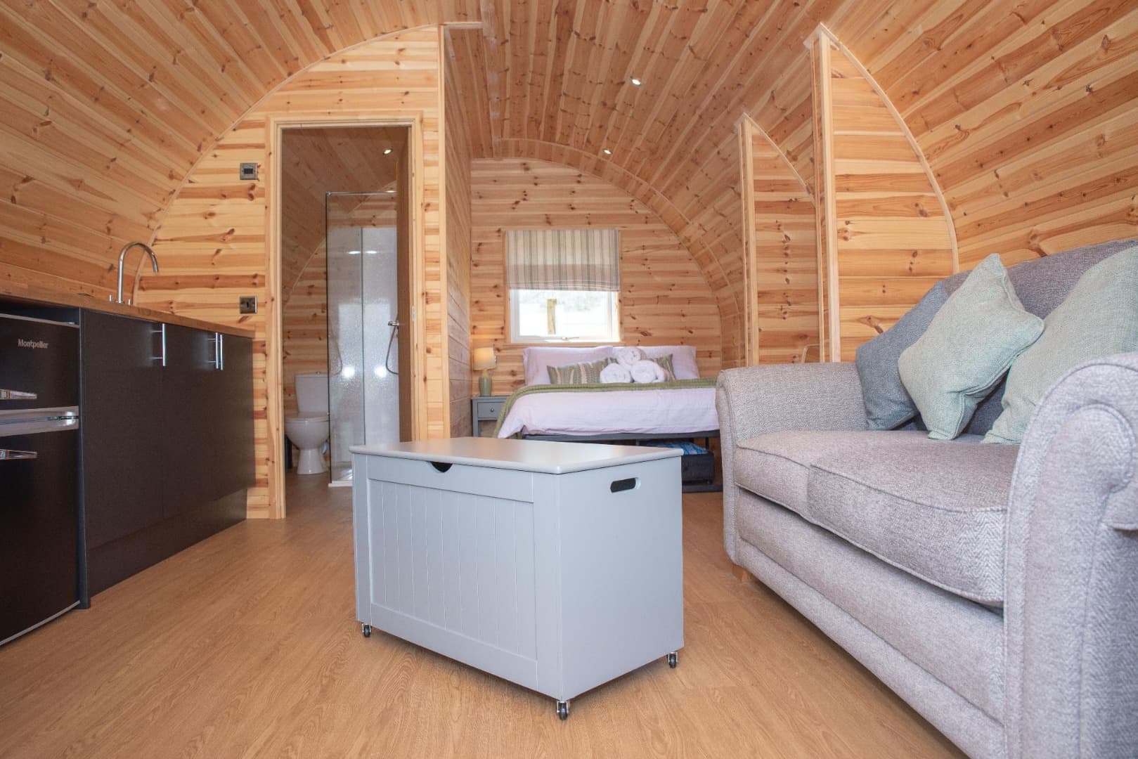Inside a pod: the kitchen, storage box, sofa bed and en-suite door