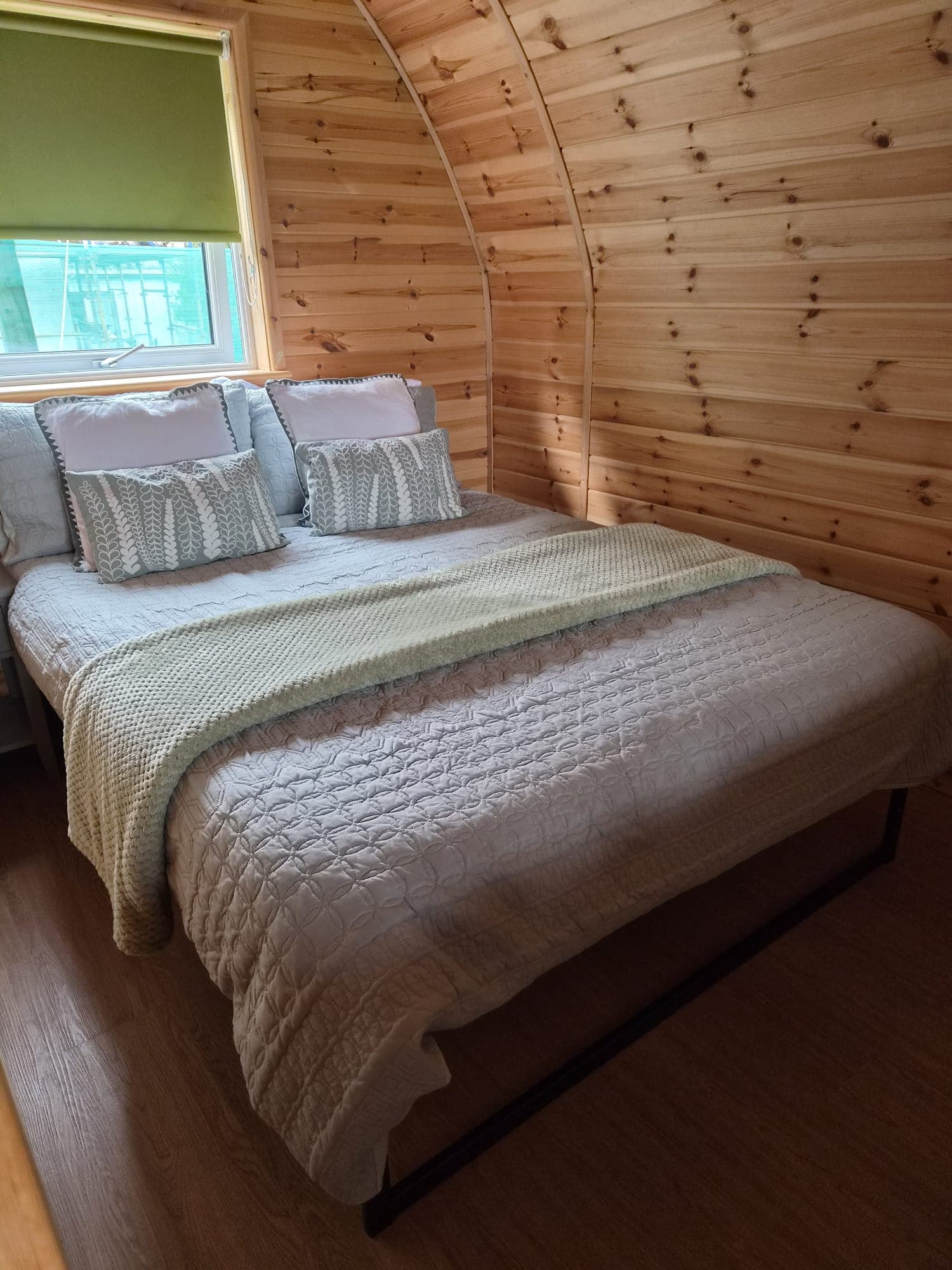Inside the Rose Pod: the double bed with sage green furnishings
