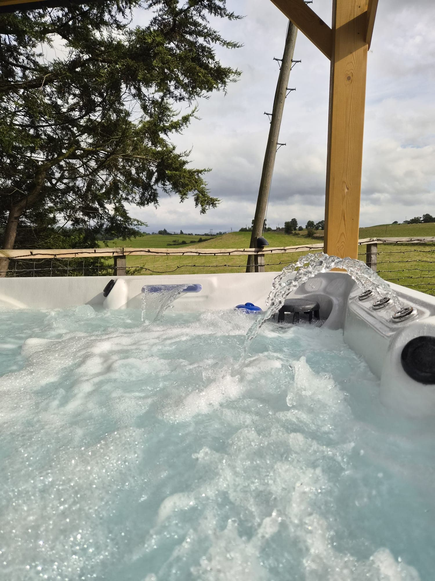 Jets arcing across the Thistle Pod hot tub under the gazebo