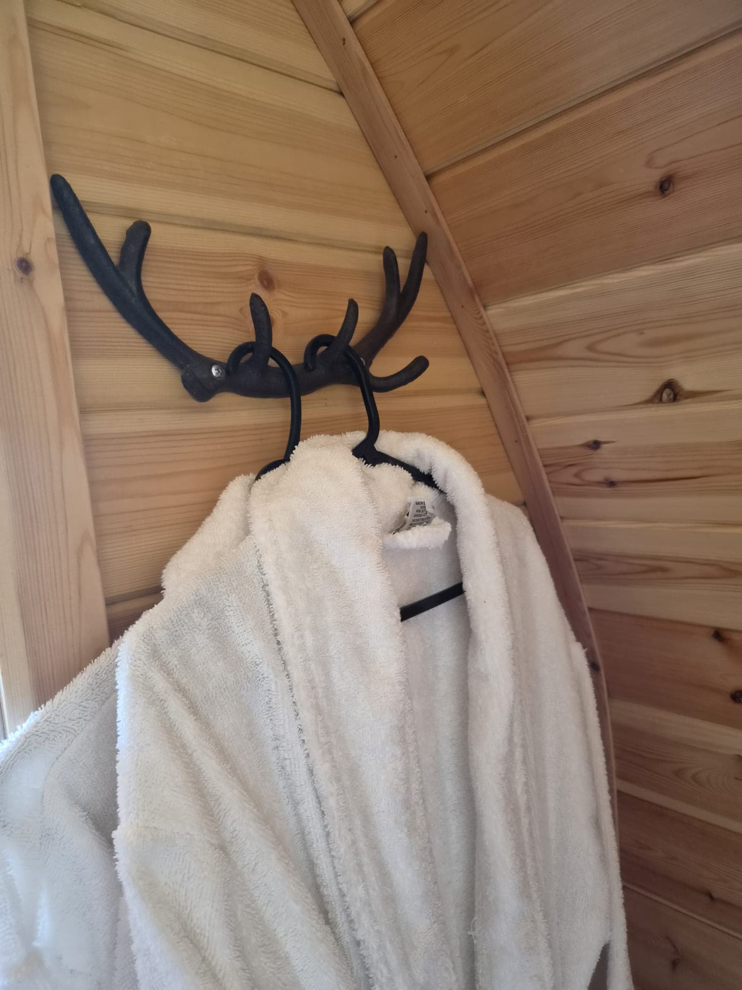Waffle robes hung on an antler hook in the Thistle Pod